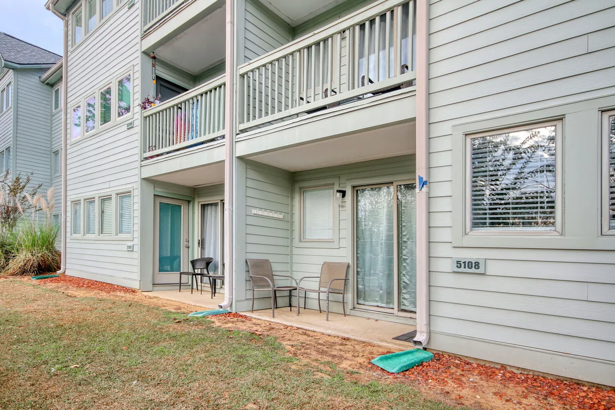 A cozy balcony with comfortable seating and a view, inviting guests to relax outdoors. The balcony is connected to the condo unit and offers space for socializing or simply enjoying the fresh air and resort ambiance.